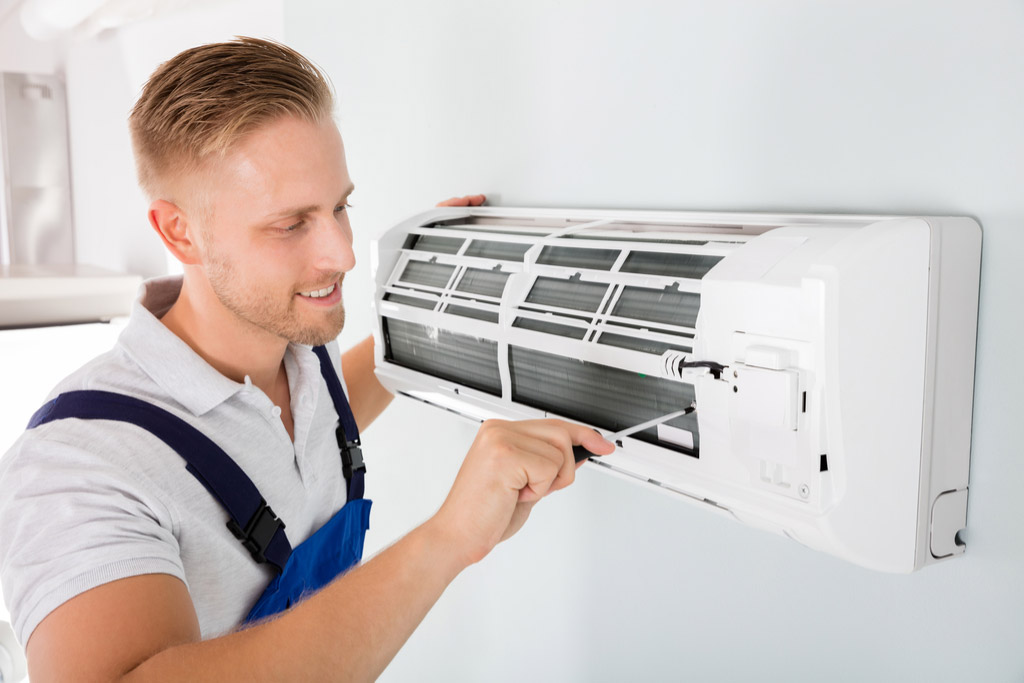 HVAC technician performing ductless air conditioning maintenance in Fountain Hills