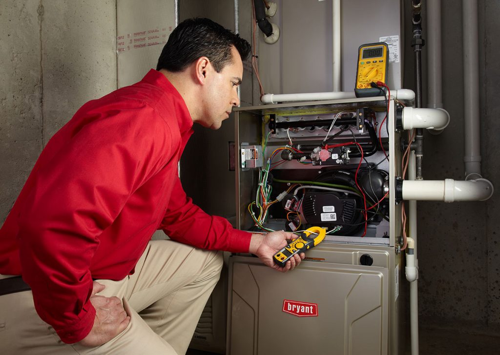 HVAC technician repairing an indoor furnace in Fountain Hills