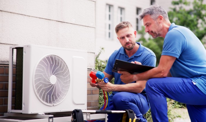 HVAC technicians installing an outdoor air conditioning unit in Fountain Hills