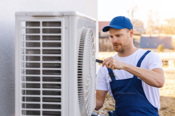 HVAC technician servicing an outdoor air conditioning unit in Fountain Hills
