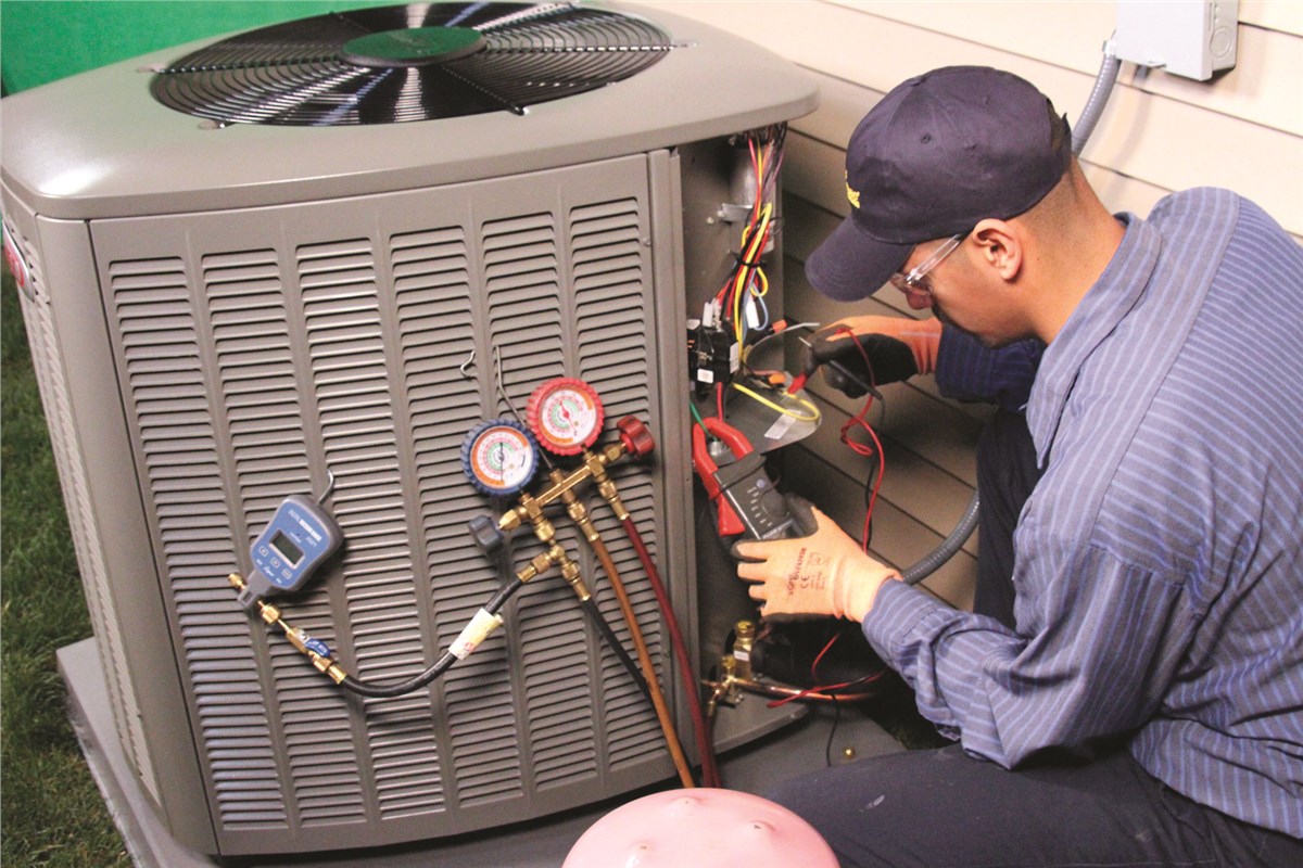HVAC technician testing an outdoor air conditioning unit in Fountain Hills