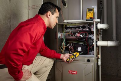 furnace repair Heating and air conditioning technician servicing an indoor furnace in Fountain Hills, AZ